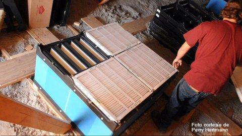 Installation of air filters and pre-filters over the inlets of an attic ventilated sow farm. Picture courtesy by Perry Hartmann